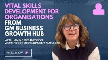 A staff member promoting videos for training reading "Vital Skills Developments for Organisations"