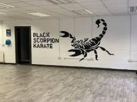 A painting of a scorpion on the wall with the works Black Scorpion CIC beside it