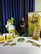 A picture of Lathan stood at an FC Tyro display