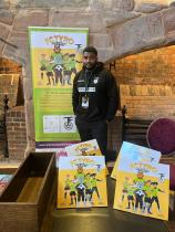 Lathan stood at a display showcasing his books