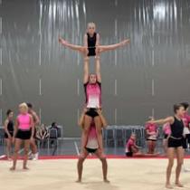 An image of 3 girls stood on each others shoulders
