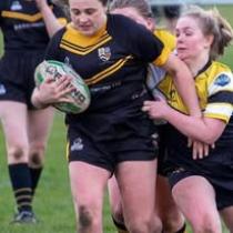 2 women [laying rugby