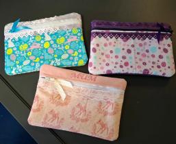 Close-up of three Easter-themed handmade fabric purses. The one in the middle reads "MUM".